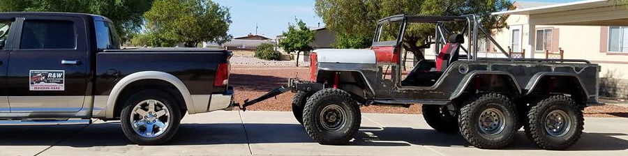 6 x 6 Jeep towed on the road.
